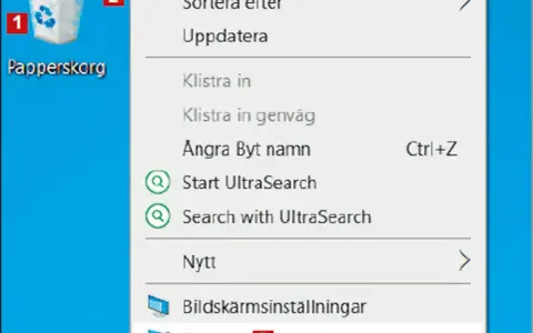 Här är en skärmdump av en dator där man kan se en ikon för "Papperskorg" och en meny. Var hittar jag papperskorgen? Den är markerad med siffran 1.