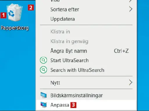Här är en skärmdump av en dator där man kan se en ikon för "Papperskorg" och en meny. Var hittar jag papperskorgen? Den är markerad med siffran 1.