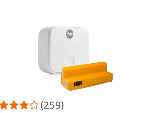 Vit Yale Access Module v2n och en orange adapter.