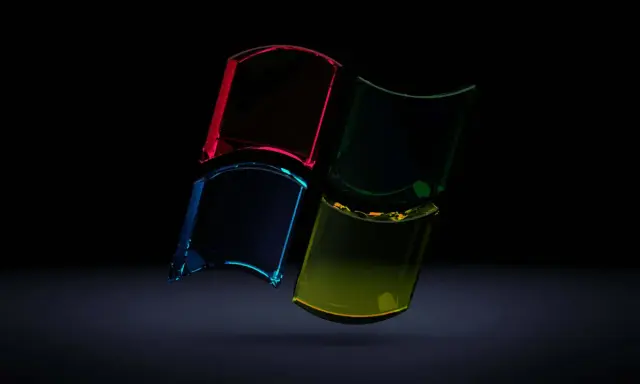 Snygga bakgrundsbilder dator: Fyrdelat Windows-logotyp i glas med lysande färger mot mörk bakgrund.